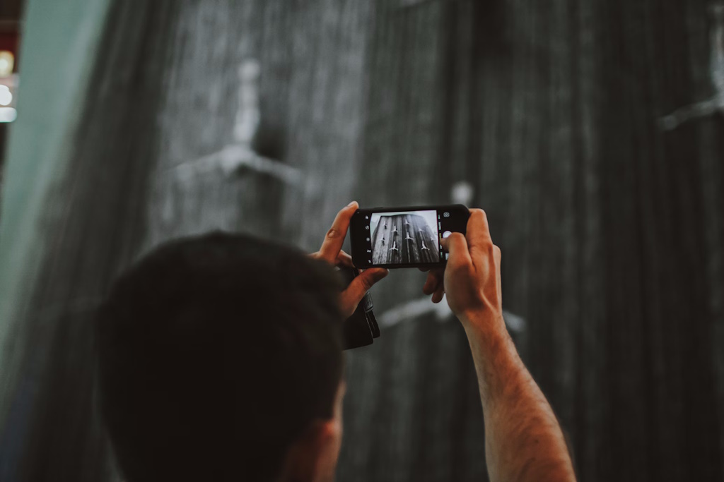 A man taking a picture of a building.