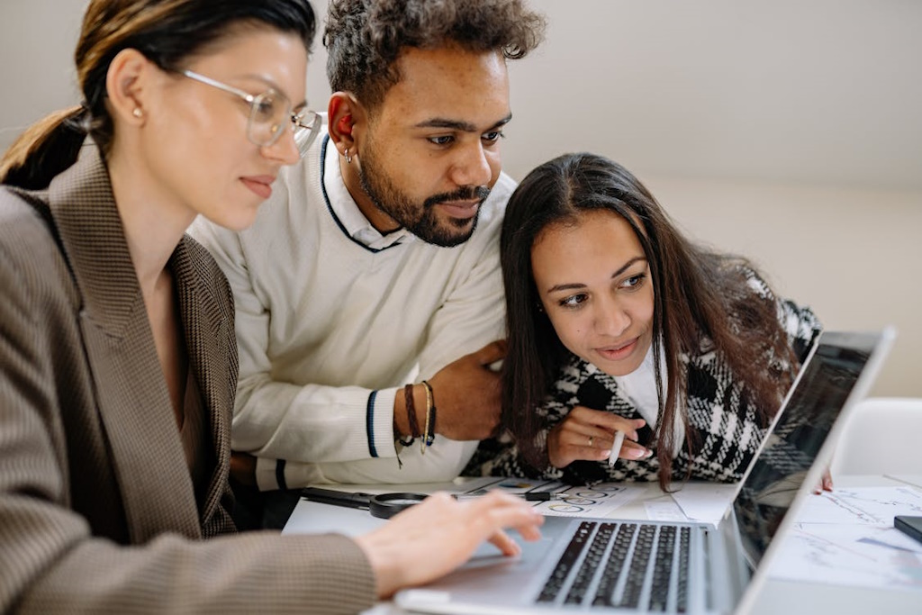 People looking at laptop.