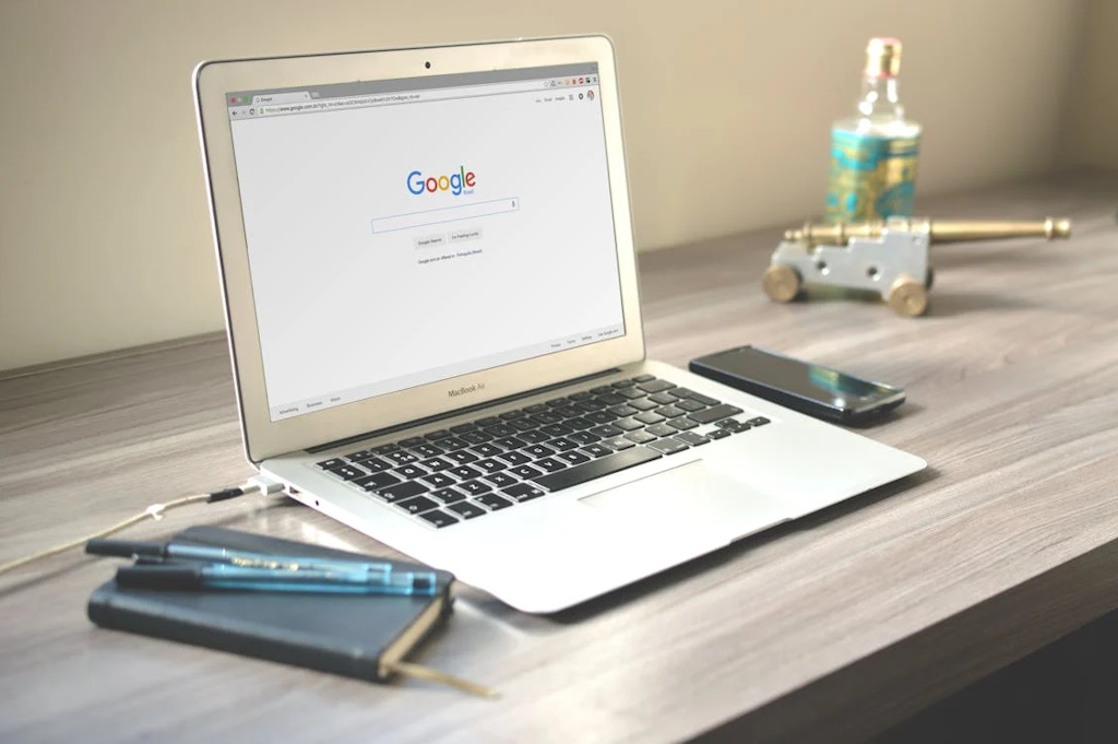 an image of macbook on a wooden desk