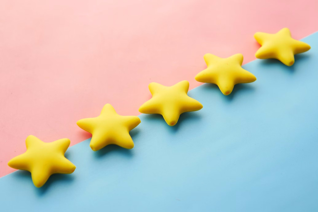 Five yellow stars on pink and blue background.