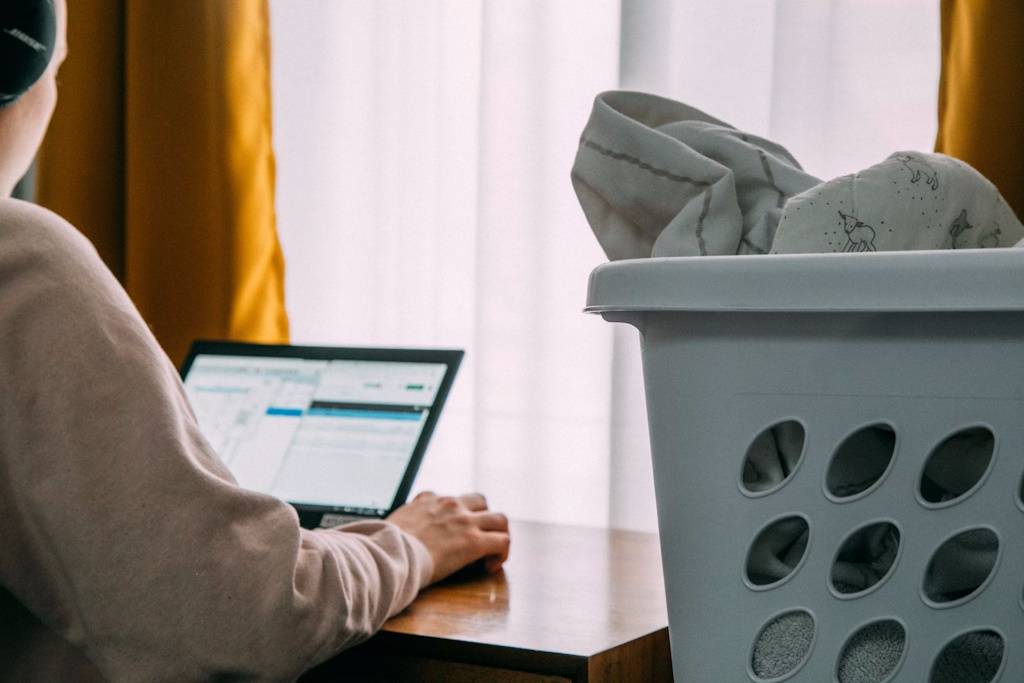 woman working from home while doing laundry